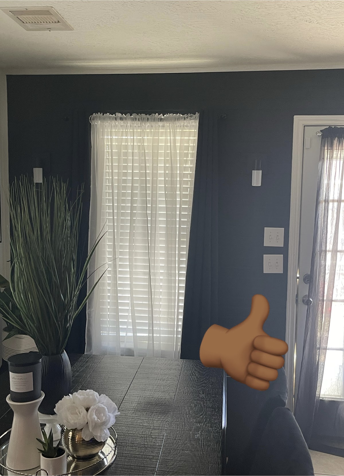 Dramatic dark navy accent wall in dining area